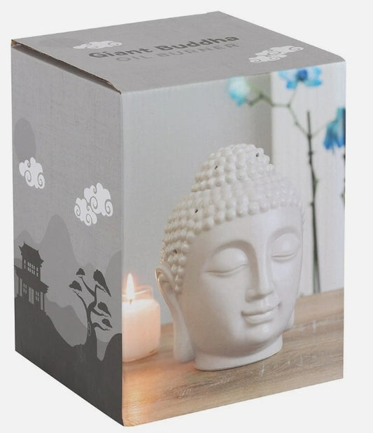 A square product box for a 'Giant Buddha' wax burner, featuring a printed image of a grey Buddha head  on a wooden surface next to a lit candle.