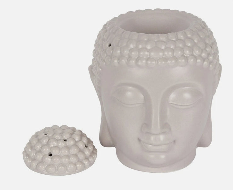 A grey ceramic Buddha head Wax Burner with dome-shaped lid placed beside it.